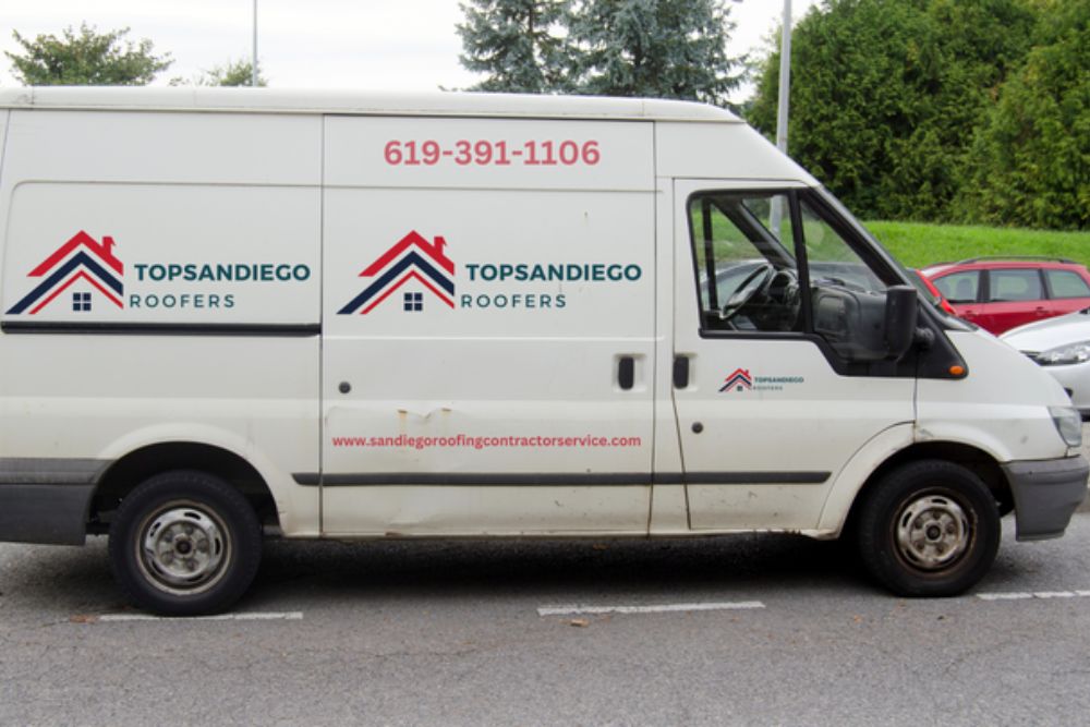 A white van featuring the name "topmanco," specializing in roofing services in San Diego, CA.